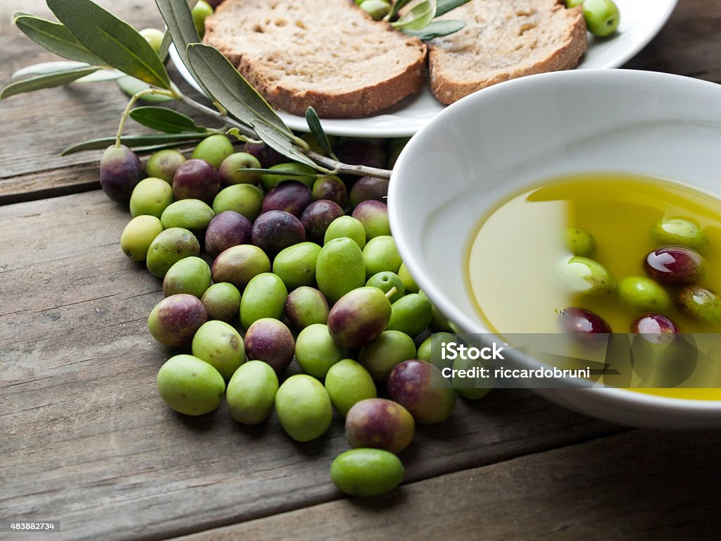 olive oil and olives OLYMPUS DIGITAL CAMERAolive oil and olives on wood Jar Stock Photo