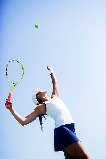 istock Beautiful female tennis player serving 483890598