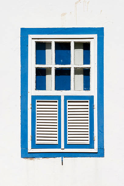 Pirenopolis, Goias, Brazil - July 5, 2009: Typical colored colonial house window located in the centre of this small city located in West Central Brazil and founded by the Portuguese in October 7th 1727. Tourism is focused on its colonial architecture, restaurants with international cousine, bars, waterfalls and the popular festival held once a year called Festa do Divino.