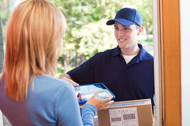 istock Delivery Person Delivering Package Box Container to Home Customer 483900324