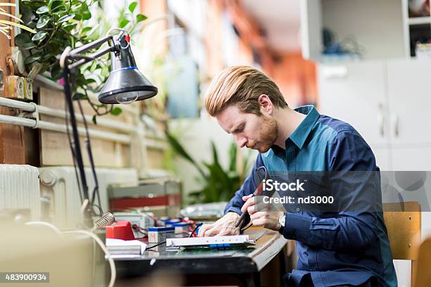 Young Handsome Man Soldering A Circuit Board Stock Photo - Download Image Now - Road Sign, Circuit Board, Computer Part