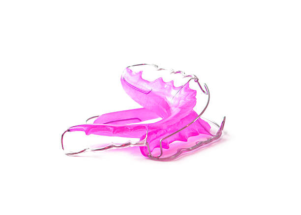 istock Pink dental retainer orthodontia, isolated on white background 483904482