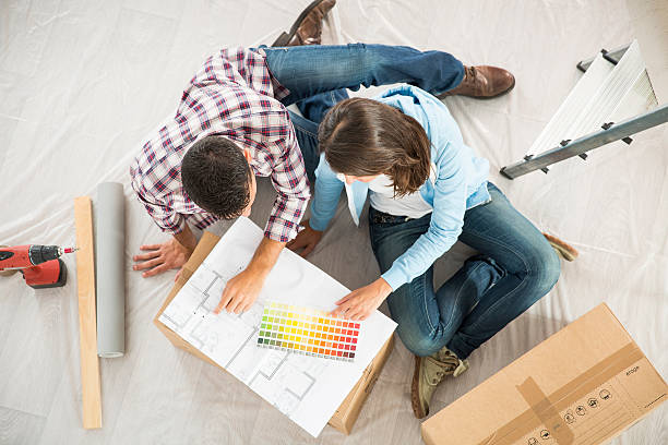 istock couple in new home choosing wall paint colors 483905158