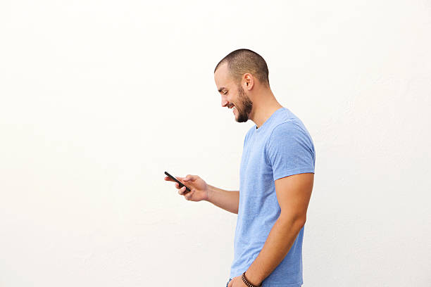 istock Handsome man with beard walking with mobile phone 483905304