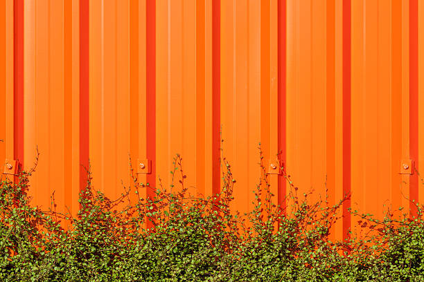 istock Bright orange corrugated painted metal wall background. 483909738