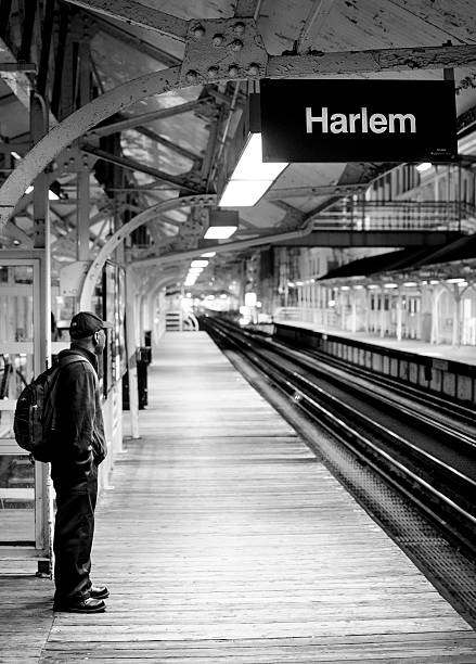 Chicago, United States - May 25, 2013: Man waiting alone on platform for subway to arrive at Harlem station. 
