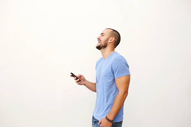 istock Cheerful young man walking with mobile phone 483910176