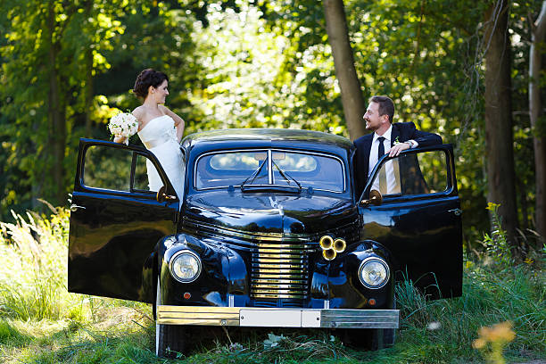 istock Wedding couple with old car 483910332