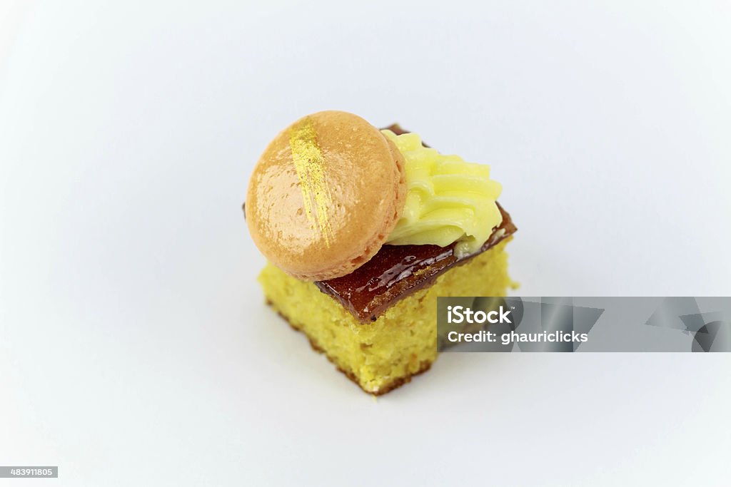 Orange and Almond Cake Orange and Almond Cake with white chocolate ganache and orange macaron Multi Colored Stock Photo
