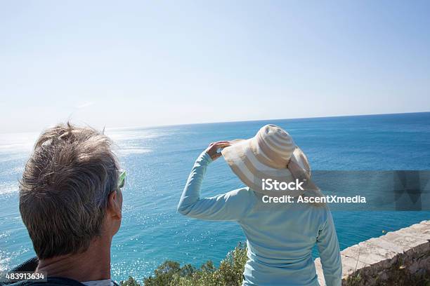 Couple Look Out Over Mediterranean Coastline In Liguria Italy Stock Photo - Download Image Now