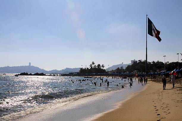 istock Mexican flag, sand and sea at Acapulco 483917140