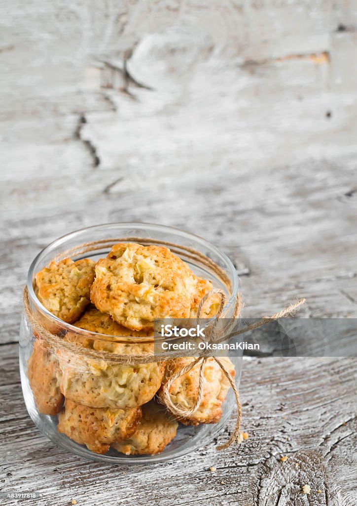 oatmeal cookies with apples in a glass jar oatmeal cookies with apples in a glass jar on a light wooden background; Cookie Stock Photo