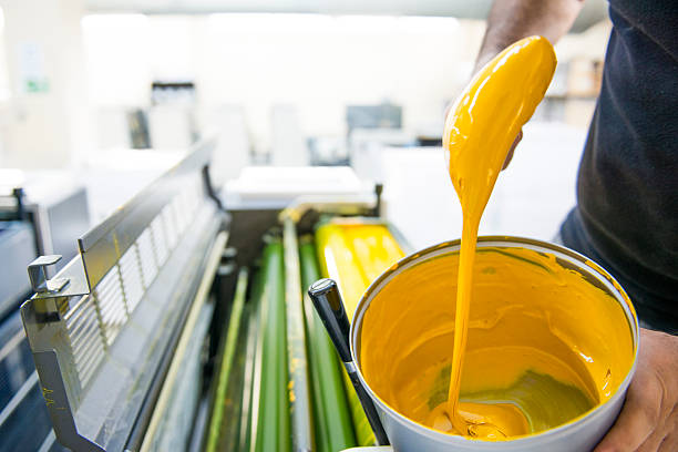 yellow colors of printing inks The workers put the yellow color printing machine mixing stock pictures, royalty-free photos & images