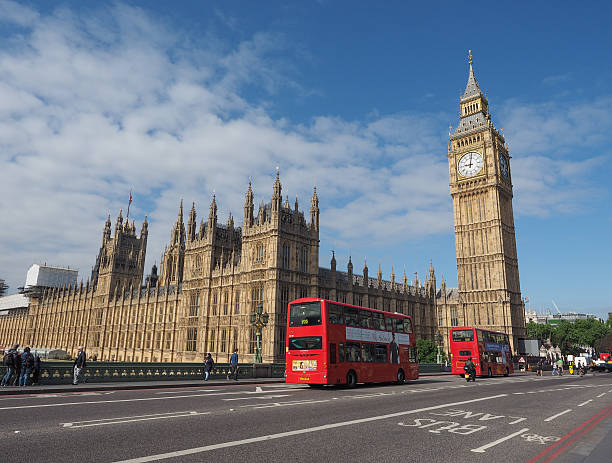 Houses of Parliament in London London, UK - June 10, 2015: Westminster Palace is the seat of the Houses of Parliament. Seen from Westminster Bridge with some people visible. big ben stock pictures, royalty-free photos & images
