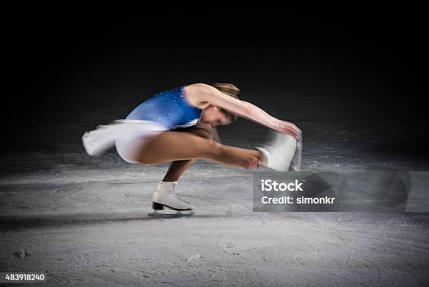 Young Female Figure Skater Performing Stock Photo - Download Image Now - Figure Skating, Ice-skating, Spinning
