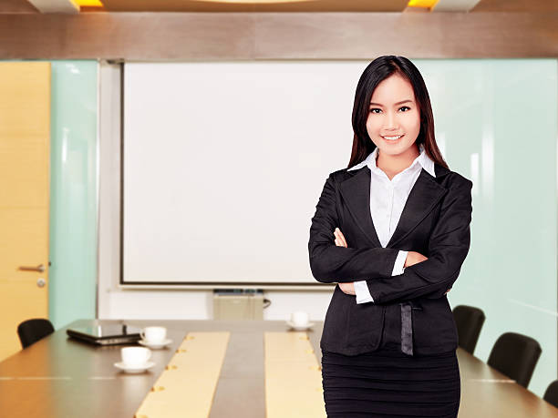 istock Asian business woman with folded hand smiling 483918572