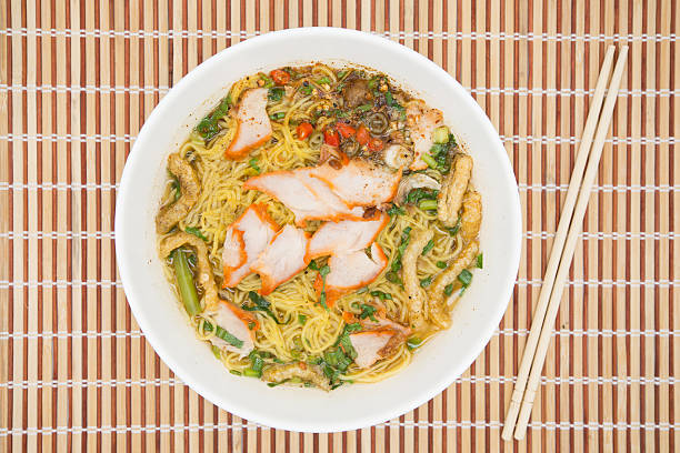Egg noodle soup with red roast pork, top view
