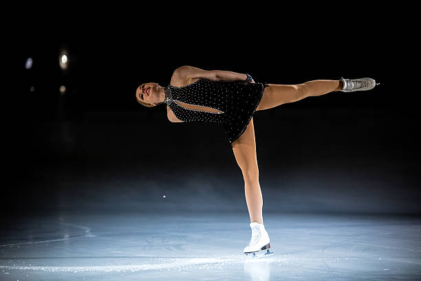 istock Young female figure skater performing 483923848