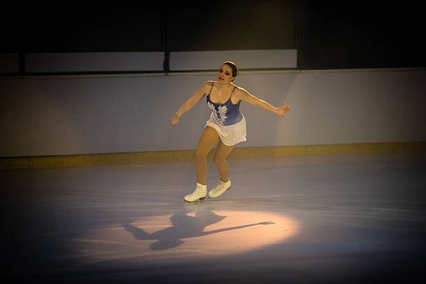 istock Young female figure skater performing 483923878