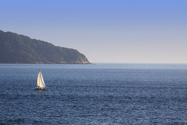 istock Sailing boat floating alone in the sea 483924530