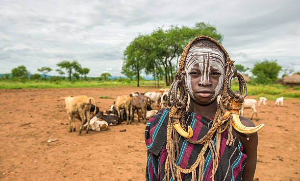 Young boy from the African tribe Mursi, Ethiopia Omo Valley, Ethiopia - May 7, 2015 : Young man from the African tribe Mursi with traditional horns in Mago National Park, Ethiopia. omo river photos stock pictures, royalty-free photos & images