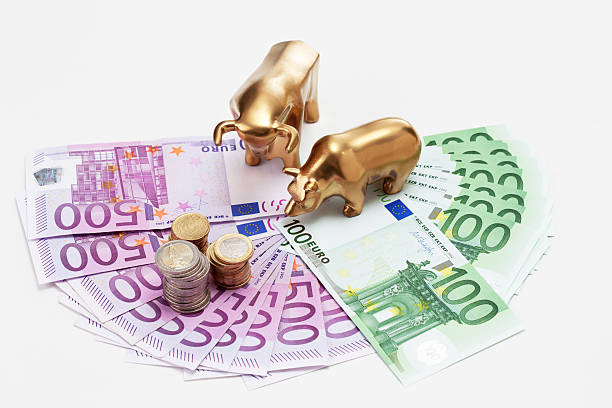 istock Golden bear and bull figurines with euro coins 483929006