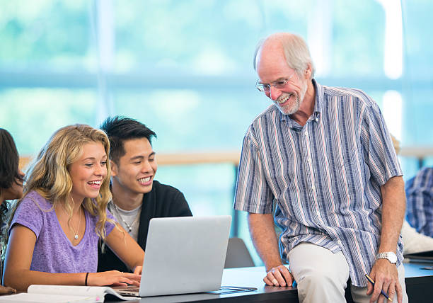 istock Group of university students with teacher in classroom 483929658