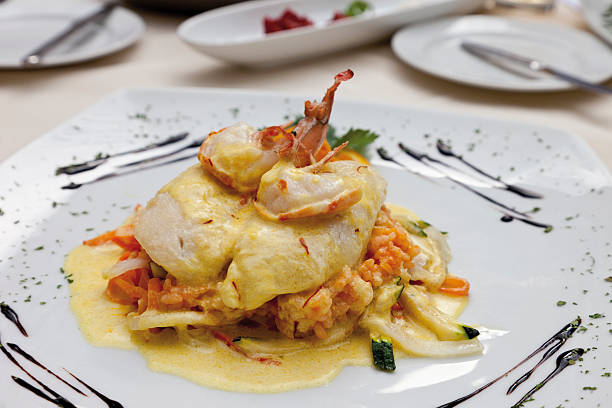 istock Pike perch fillet with scampi, basmati rice, braised vegetables 483930010