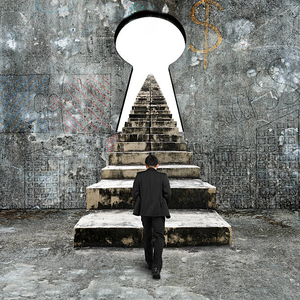 istock Man climbing old concrete stairs toward keyhole 483932992
