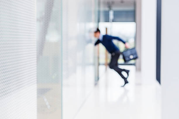 Businessman running thru an empty hall.