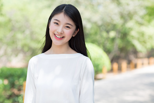 beautiful asian girl, spring green bokeh background.