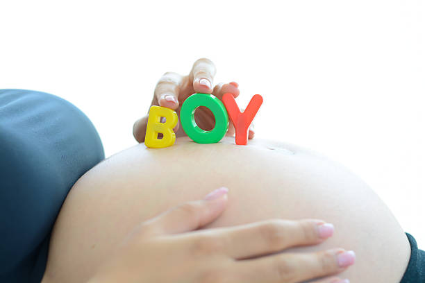 istock Young expectant mother spelling boy on her pregnant belly 483934508