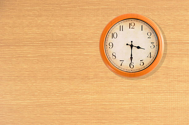 istock Clock showing 3:30 o'clock on a wooden wall 483936342
