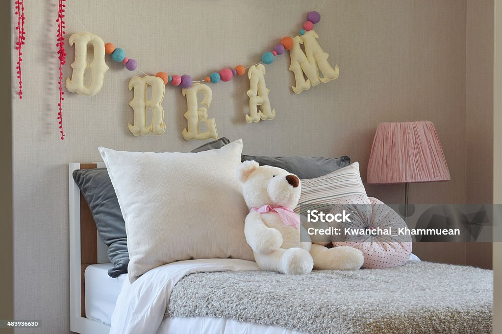 modern kids room with doll and pillows on bed Child Stock Photo