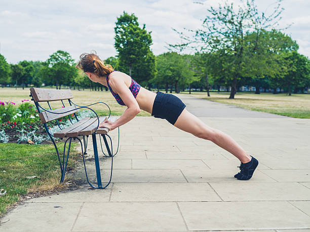istock Fit woman doing plank on bench 483936654