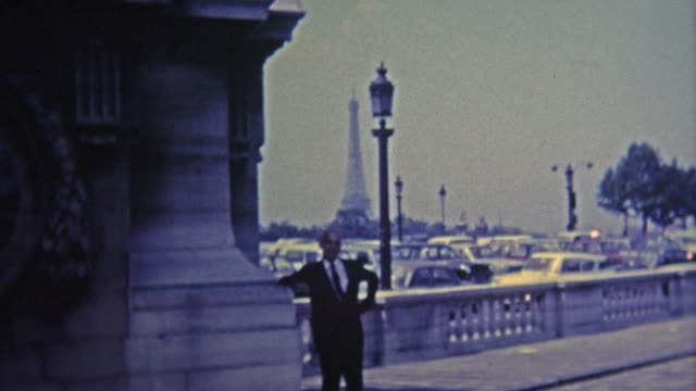 PARIS, FRANCE - 1969: Proud frenchman poses by his Eiffel Tower.