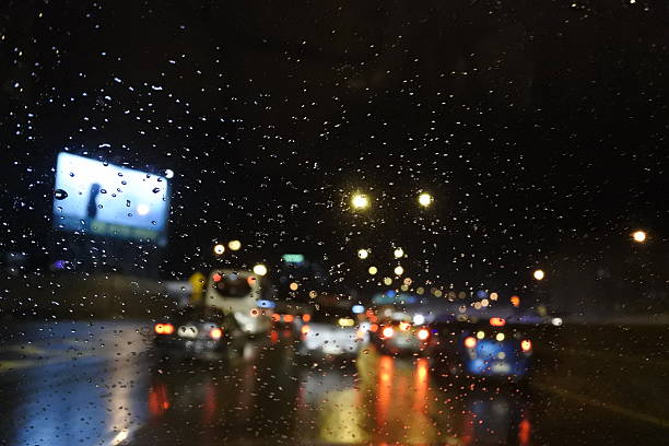 istock Rain drops on window with street bokeh lights 483936946