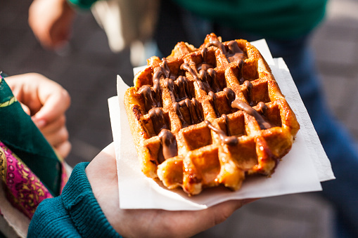 Typical belgian waffle in the street, ready to eat.