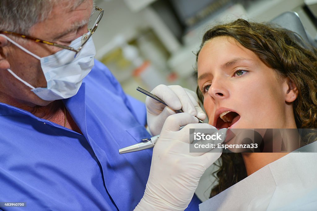 Women at Dentist Woman undergoing dental procedure 20-24 Years Stock Photo