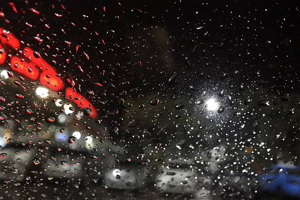 istock Rain drops on window with street bokeh lights 483940790