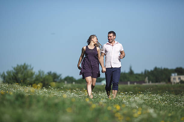istock Couple running in field and have fun 483943546