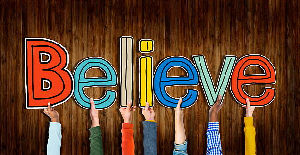 istock Group of Hands Holding Letter Believe 483943568