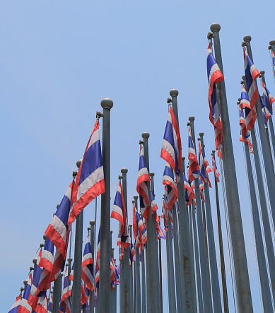 Thai national flag in blue sky in Bangkok Thailand