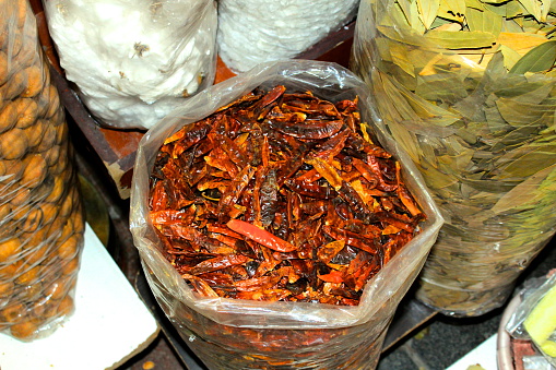 High Definition photo of bags of spices used in Arab cooking, taken in Dubai, in frame are dried chillies, bay leaves and more.