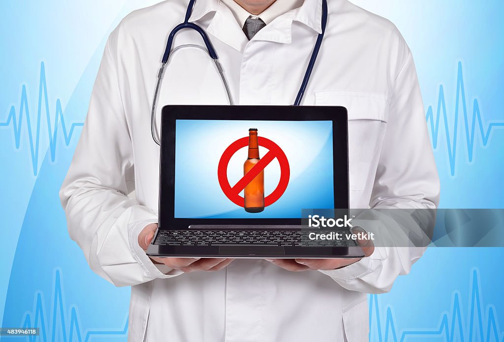 stop alcohol doctor holding laptop with stop alcohol symbol 2015 Stock Photo