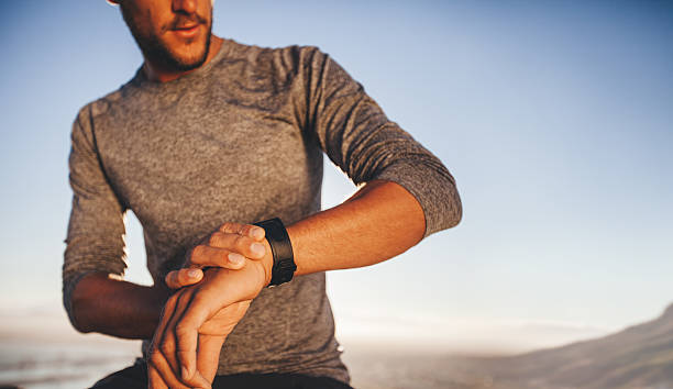 istock Young runner checking the time on his wristwatch 483946914
