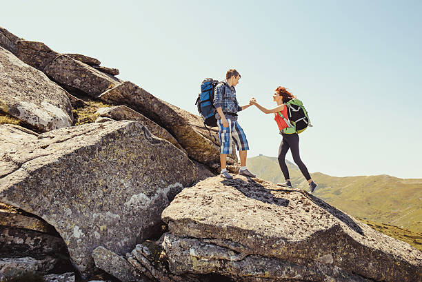 istock Young couple climbing in the mountains 483947418
