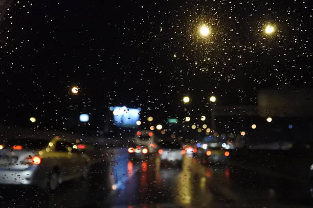 istock Rain drops on window with street bokeh lights 483947550