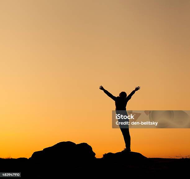 Silhouette Of Happy Young Woman Against Beautiful Colorful Sky Stock Photo - Download Image Now