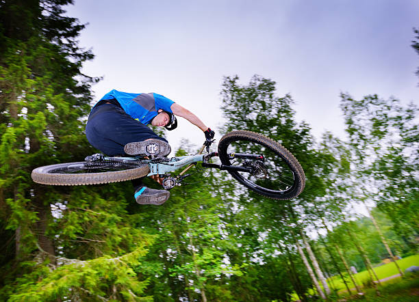 istock Fast MTB bike jump in woods 483949630